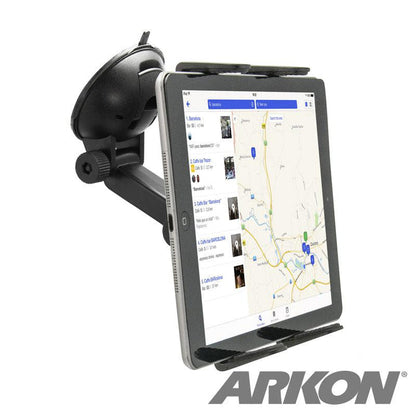 A tablet secured by the Windshield Suction Tablet Mount with Extension Arm in landscape mode displays a map app. The universal holder attaches to the black mount on the car windshield, and the ARKON logo appears in the lower right corner.